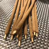 6Witch3 Hand-Rolled Resin Incense Sticks - a small pile of incense sticks shown on a loosely woven metallic mat