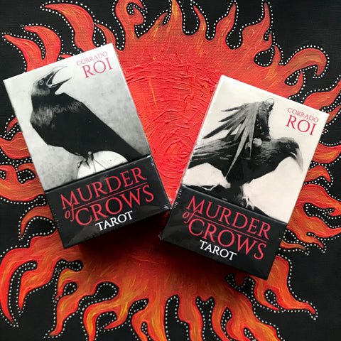 6Witch3 Murder of Crows Tarot deck by Corrado Roi - front and back of the box shown on a handpainted red and black sun background