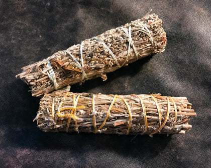6Witch3 - two 5" long bundles of black sage aka mugwort shown on a piece of dark brown leather