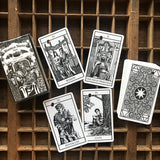 6witch3 Bianco Nero tarot, box, stack of cards facedown, and four card spread