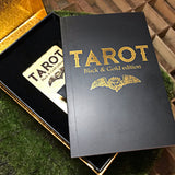 6Witch3 Tarot Black & Gold Edition - A shot of the opened box, the deck laying inside with the handbook placed diagonally atop it.
