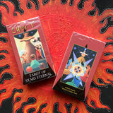 6Witch3 Liber T Tarot of Stars Eternal - two boxes showing the front and back displayed on a handpainted red and black sun background