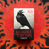 6Witch3 Murder of Crows Tarot deck by Corrado Roi - front of the box shown on a handpainted red and black sun background